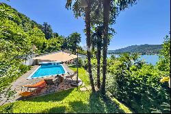 Charming small villa with a pool in Montagnola for sale, offering a spacious view of the 