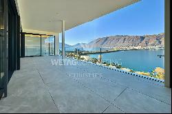 For sale in Lugano-Bissone elegant apartment with terrace & magic lake view