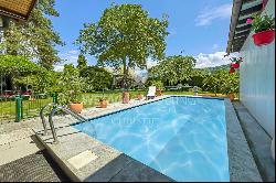 Lugano-Magliaso: charming villa for sale, nestled in lush greenery, featuring a swimming 