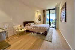 Lugano-Comano: elegant duplex apartment for sale with partial lake view, private garden &