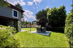 For sale in Montagnola magnificent villa with large flat garden, SPA area & enchanting pa