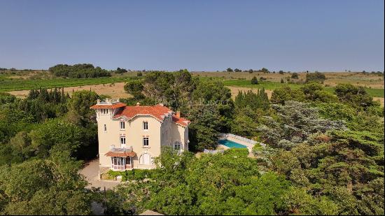 Mansion in a green setting.