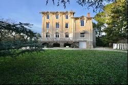 Mansion in a green setting.