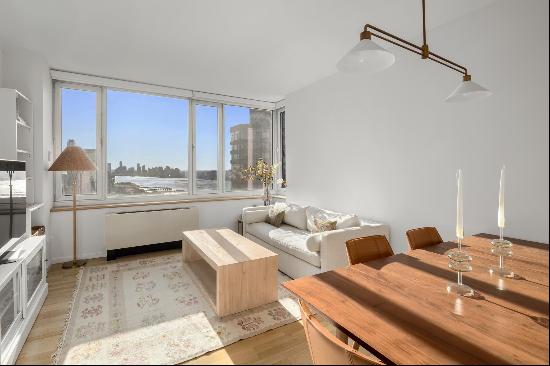 SWEEPING VIEWS over the skyline and the Hudson River from this sun-flooded, bright and 