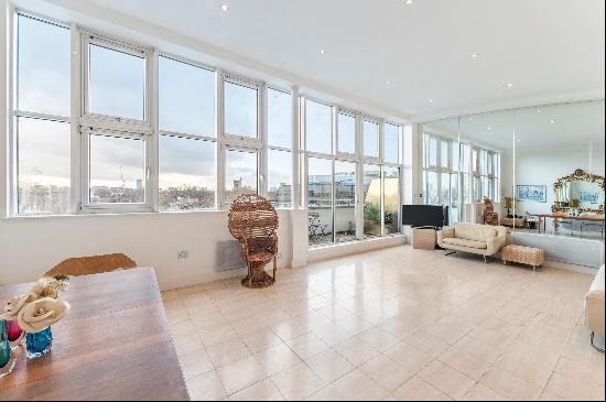 An exceptional 1,400 sq ft penthouse apartment spread across two floors. This stunning pro