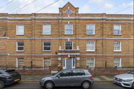 A charming two-bedroom ground floor apartment, located within a period mansion block in th