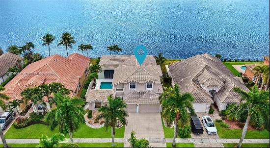 Welcome to this modern two-story courtyard home W/pool on one of Miramar's largest lakes, 