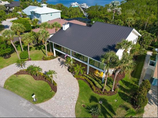 Nestled within the exclusive gated community of Joes Point on Hutchinson Island, this exqu