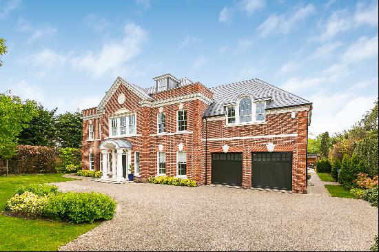 Expansive family home with private swimming pool for rent in Oxshott