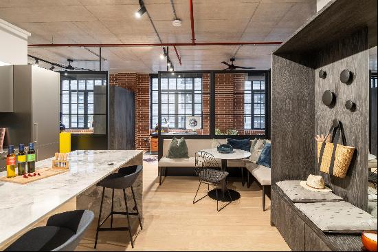 A sixth-floor,  spacious loft apartment in a warehouse-style building located on the prest