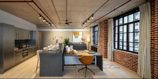 A spacious, dual aspect, loft apartment in a warehouse-style building with exposed concret