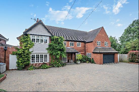 A beautifully presented family home with a heated outdoor swimming pool and pool house in 