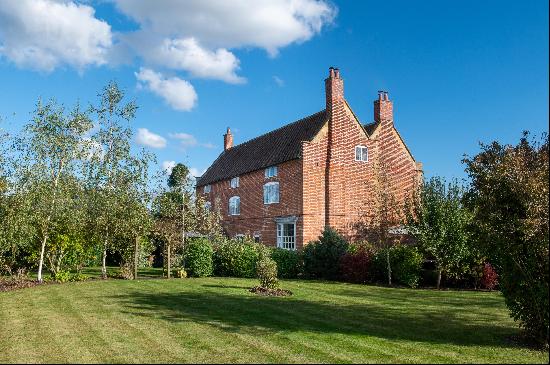 A handsome, large, restored Georgian fronted listed former farmhouse on the edge of the vi