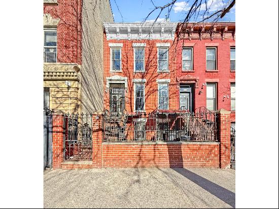 Introducing 971 Bergen Street, an early twentieth-century two-family brick townhouse lo