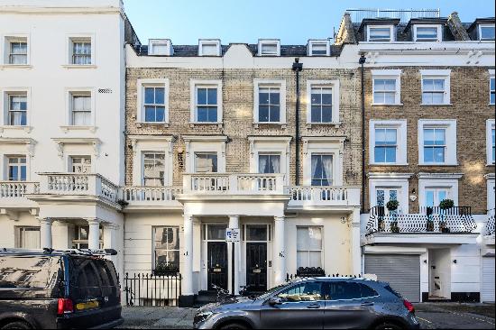 A charming and bright one-bedroom flat located on the second floor of a stunning period st