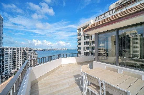 Welcome to refined living on exclusive Brickell Key Island! This 2-bedroom, 2-bathroom cor