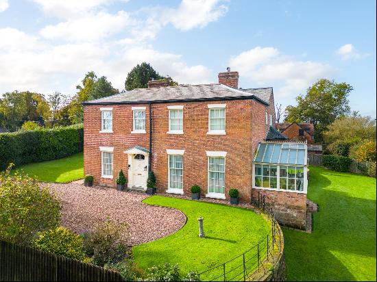 A handsome former vicarage set in private grounds on the edge of a delightful Shropshire v