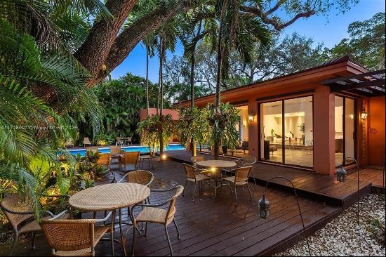 Discover the allure of this Coral Gables gem - a thoughtfully remodeled home that effortle