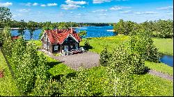 Homestead in ethnographic style on the shore