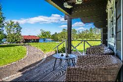 Homestead in ethnographic style on the shore