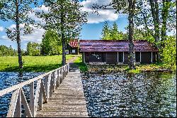 Homestead in ethnographic style on the shore