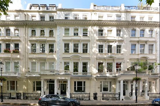 A well-presented two/three bedroom apartment for sale on a prime garden square in SW7.