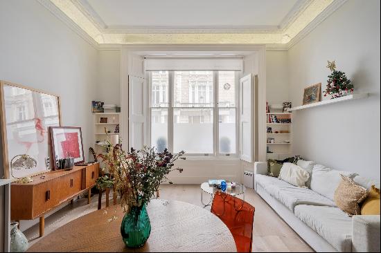 A beautifully-designed apartment boasting a reception room with over 3.6-meter ceilings an