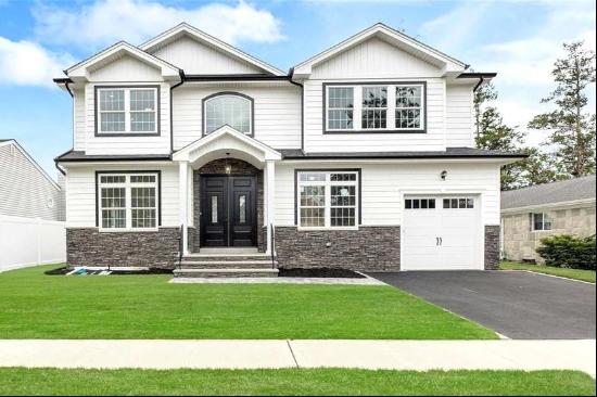 Step into luxury with this brand new 3,200 square-foot Center Hall Colonial, nestled right