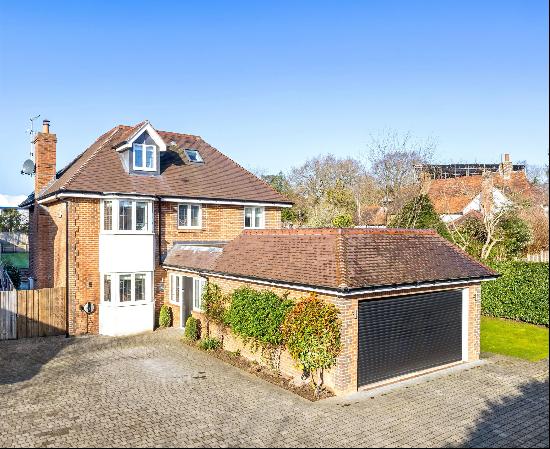 A superb five bedroom detached family home behind a gated entrance in Oxshott Village