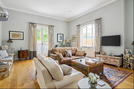 An outstanding two-bedroom apartment with high ceilings and large windows offering tree-li