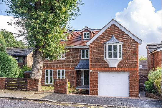 A substantial and modern five / six bedroom detached family house with a good size garden 