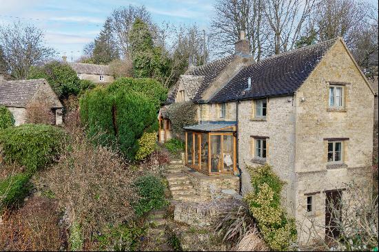 An idyllic detached Grade II listed Cotswold stone cottage set in a beautiful valley setti