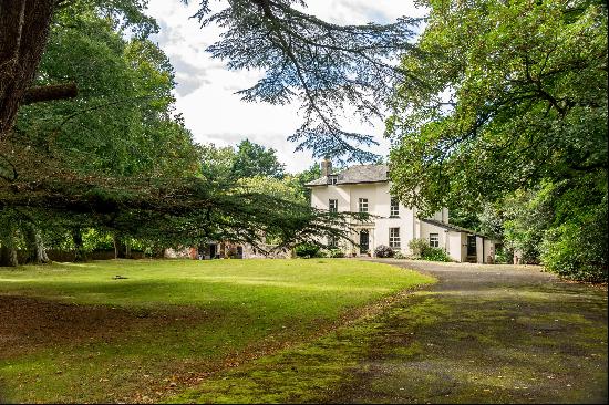 A stunning Grade II listed detached family home with generous park like grounds.