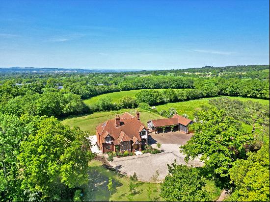 A fine country house with six bedrooms, outbuildings and extensive gardens