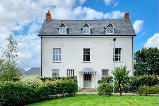 A beautifully restored and substantial Grade II Listed former farmhouse, set in a unique l