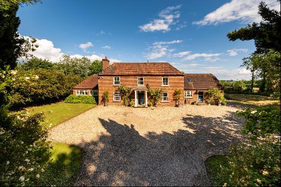 A modern six bedroom country house sitting in an elevated position with far-reaching views