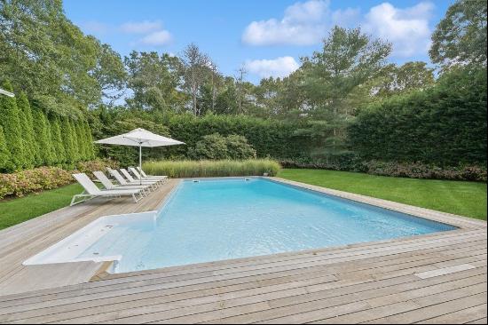 Welcome to Wainscott, where your newly renovated dream home awaits. Nestled on a quiet, tr