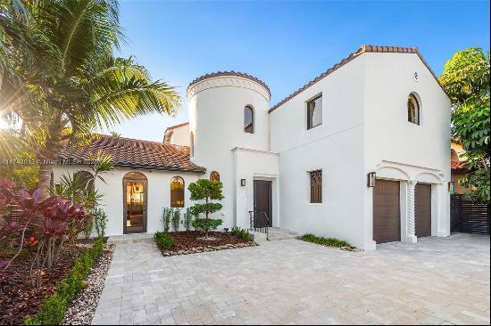 Located in the prestigious La Gorce Country Club, this impeccably designed home offers stu