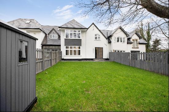 A stylish four-bedroom home with modern styling, in a sought-after setting moments from th