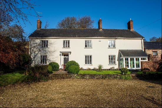 A handsome, south-facing Georgian farmhouse set amidst beautiful countryside with views ac