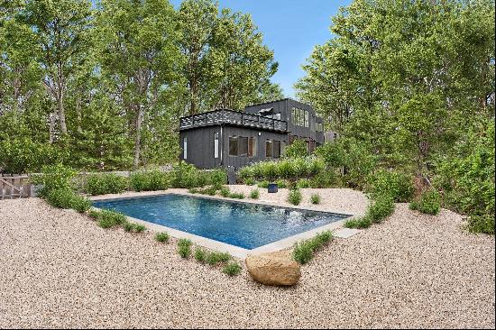 Nestled on a tranquil 3.12-acre property between the charming villages of East Hampton and