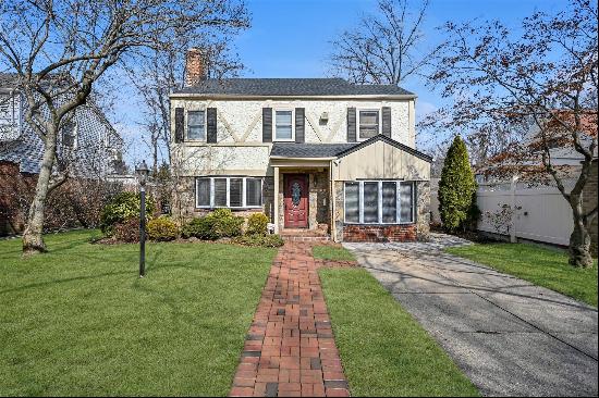 Welcome to this elegant Tudor Colonial home in the desirable neighborhood of Hollis Hills.