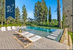 Period estate with a pool, spa and olive grove for sale on Chianti's hills